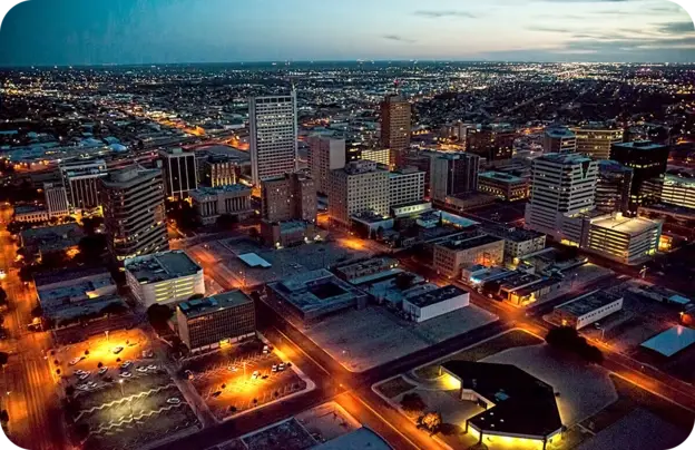 A panoramic view of Downtown Midland, TX, at dusk.