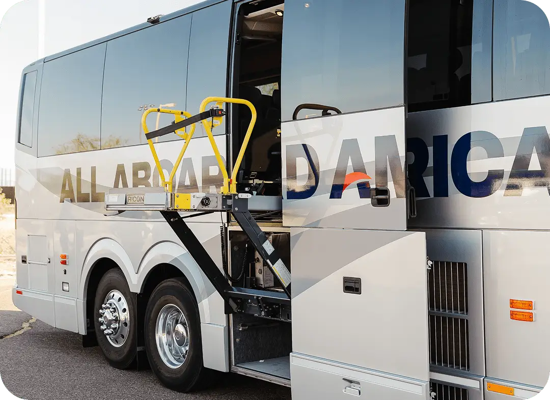 An All Aboard America motorcoach with a yellow ADA wheelchair lift deployed at the door
