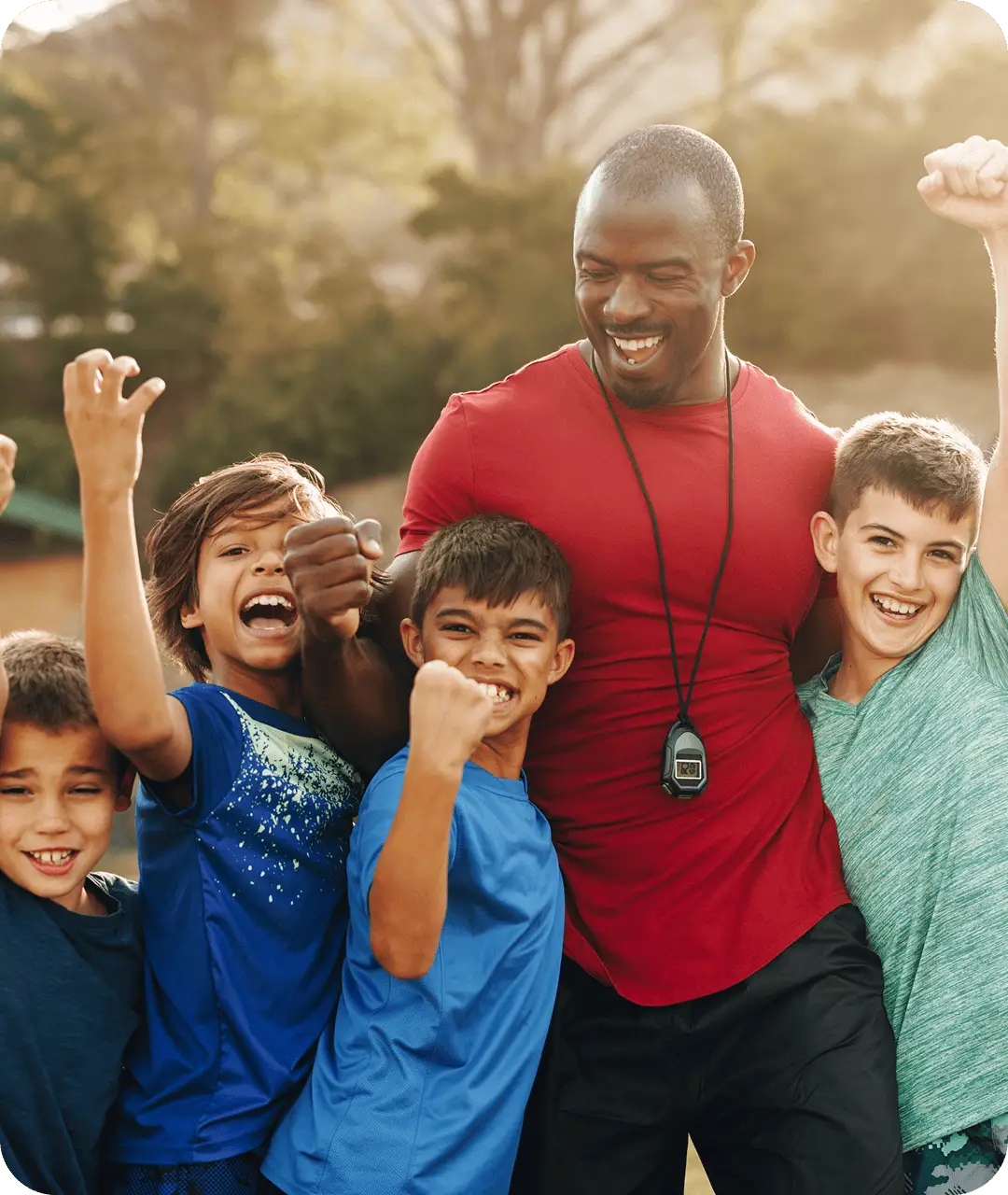 A coach and group of young students celebrate together outdoors representing K-12 school transportation
