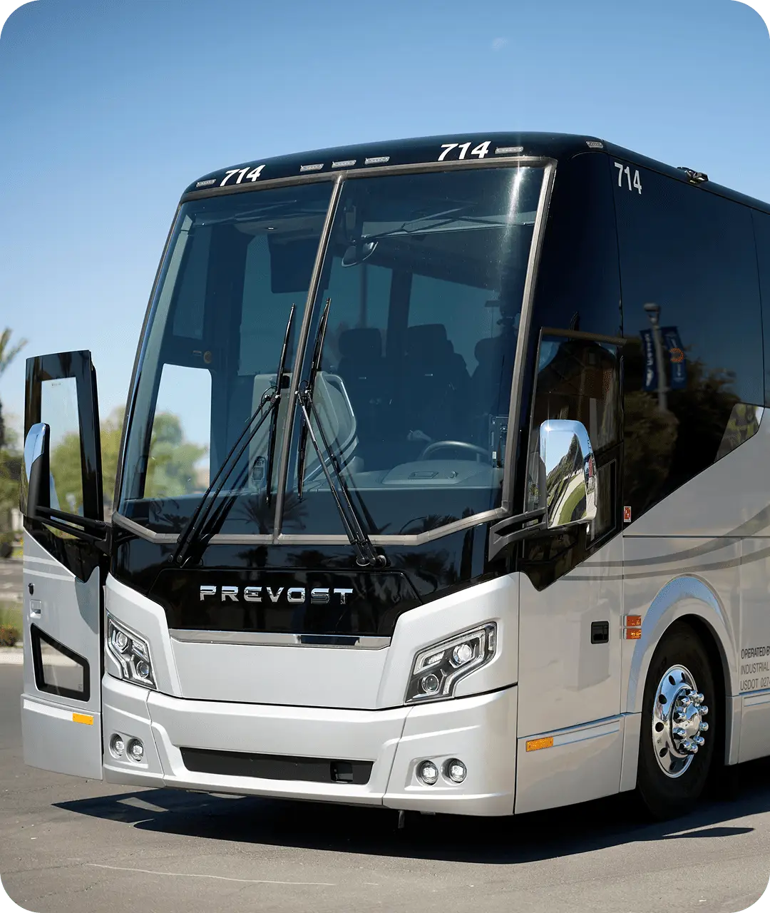 Front view of an All Aboard America Prevost motorcoach number 714 with doors open on a sunny day