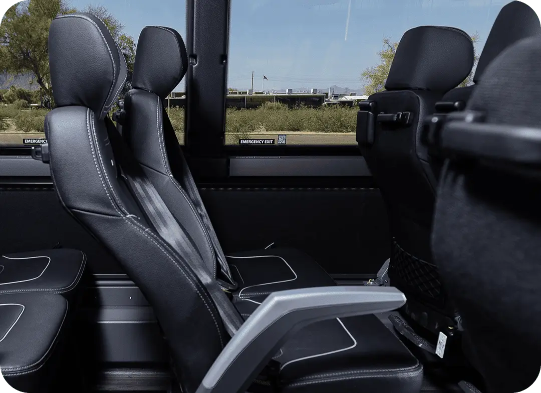 Comfortable leather reclining seats with headrests inside an All Aboard America motorcoach