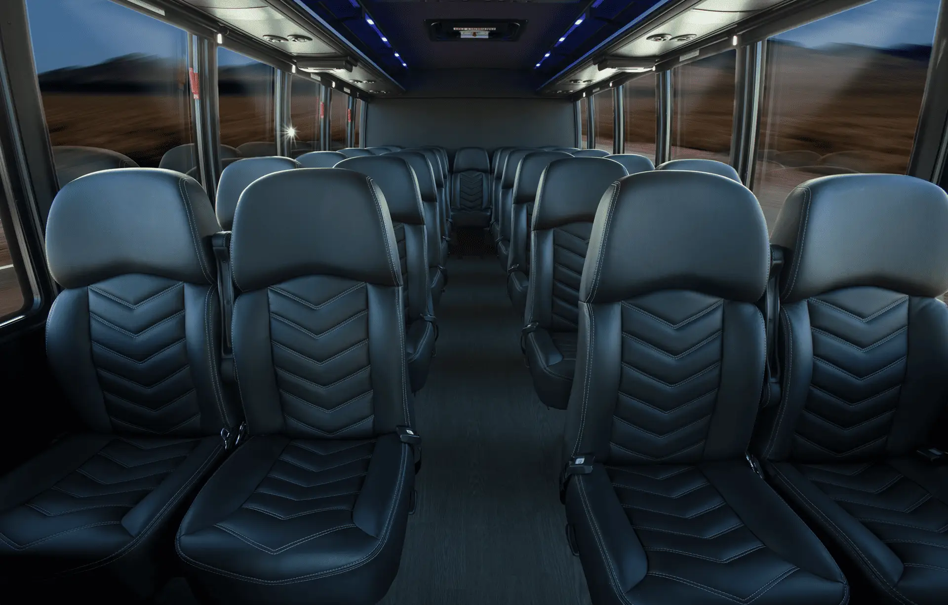 Interior of an All Aboard America mini coach showing rows of premium leather seats with ambient blue lighting