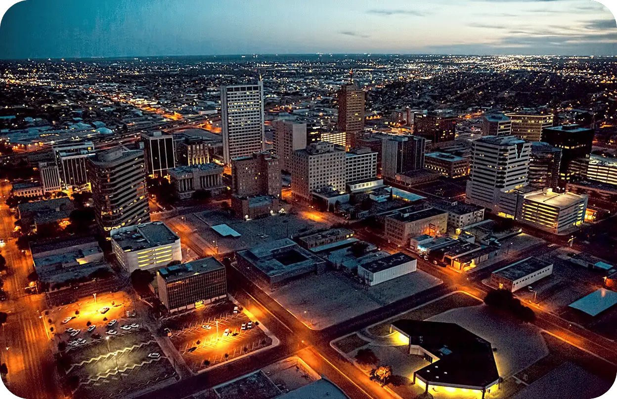 A panoramic view of Downtown Midland, TX, at dusk.