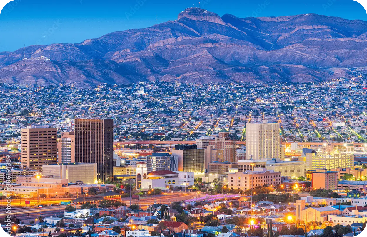 An All Aboard America driver and customer review trip details on a phone in front of a fleet of motorcoaches
