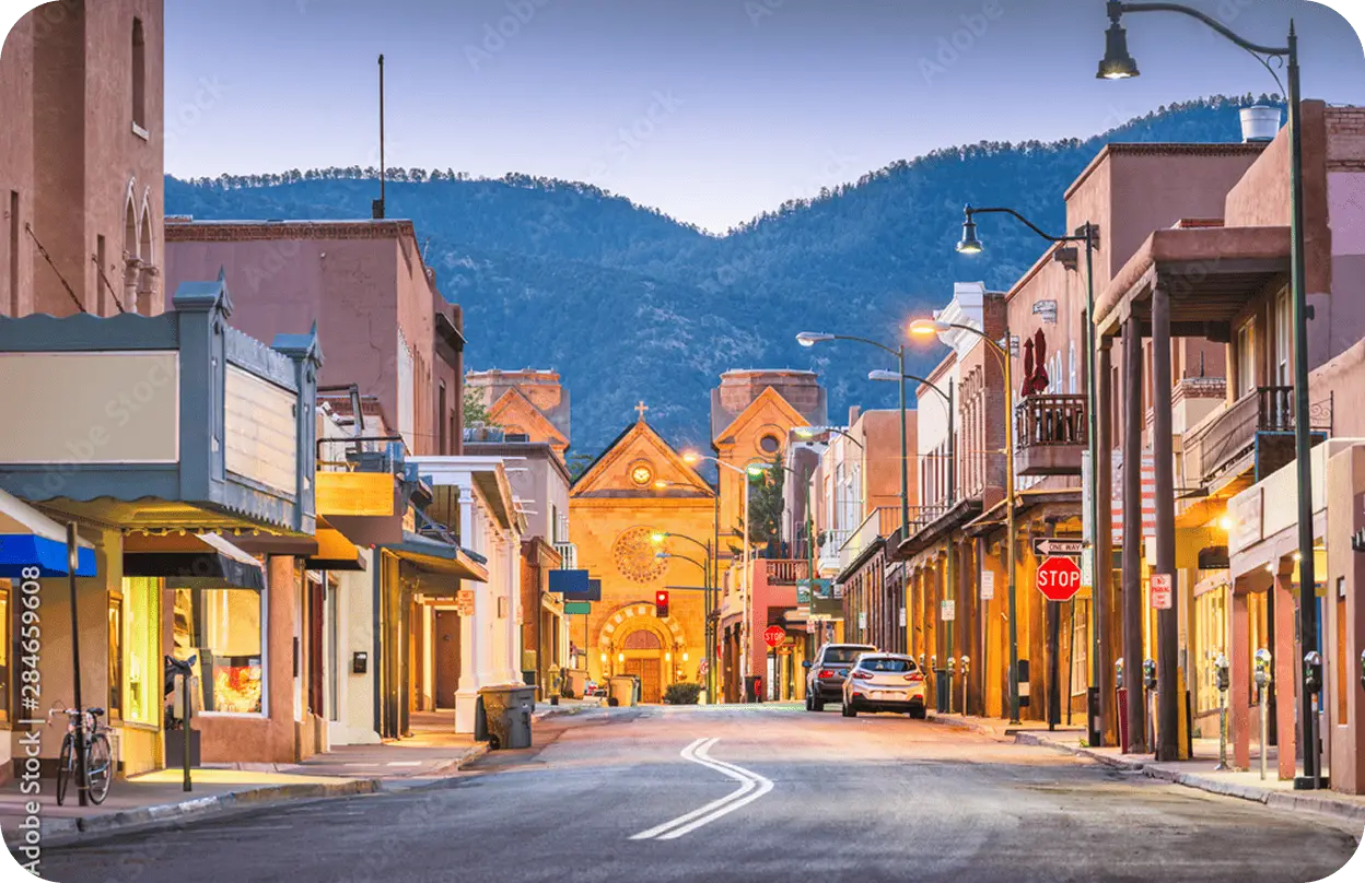 Rear view of an All Aboard America Prevost motorcoach number 714 parked in a desert lot with red rock formations