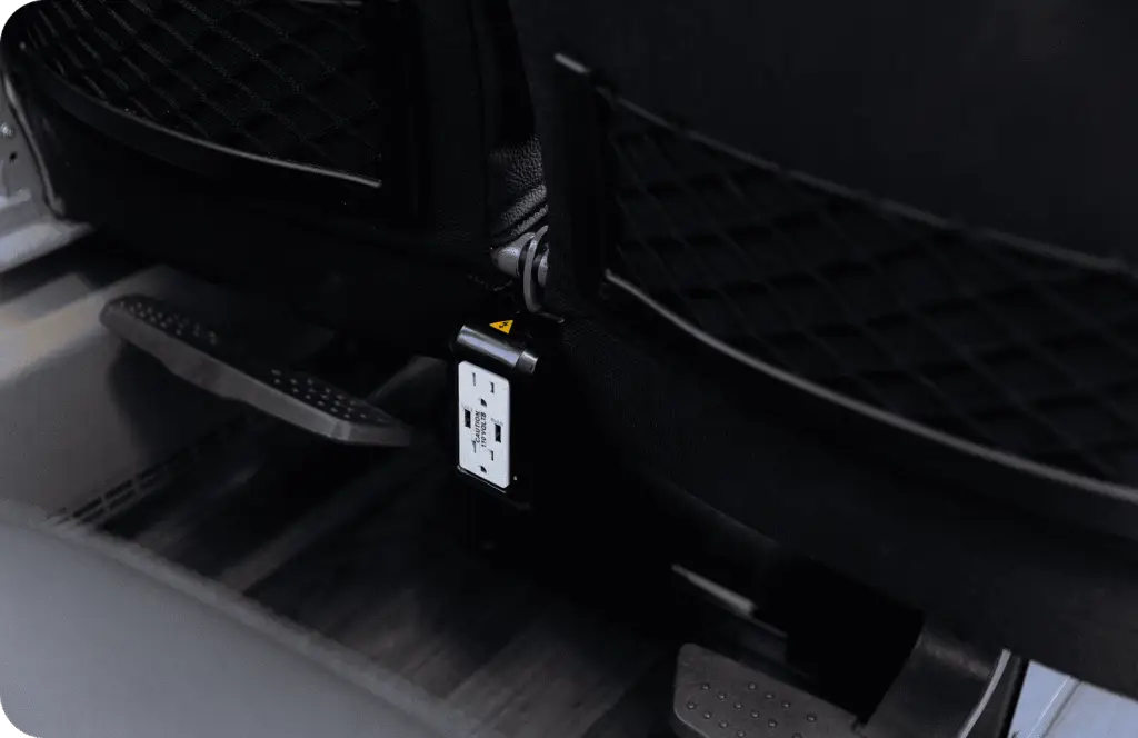 An All Aboard America Prevost motorcoach parked at dusk with desert scenery