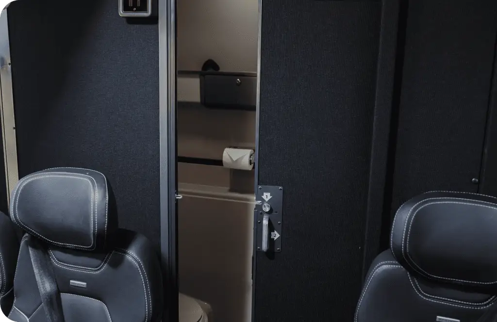 An All Aboard America Prevost motorcoach parked at dusk with desert scenery