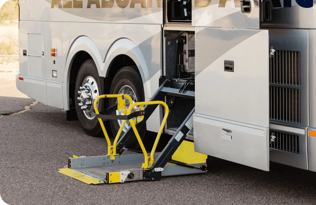 An All Aboard America Prevost motorcoach parked at dusk with desert scenery