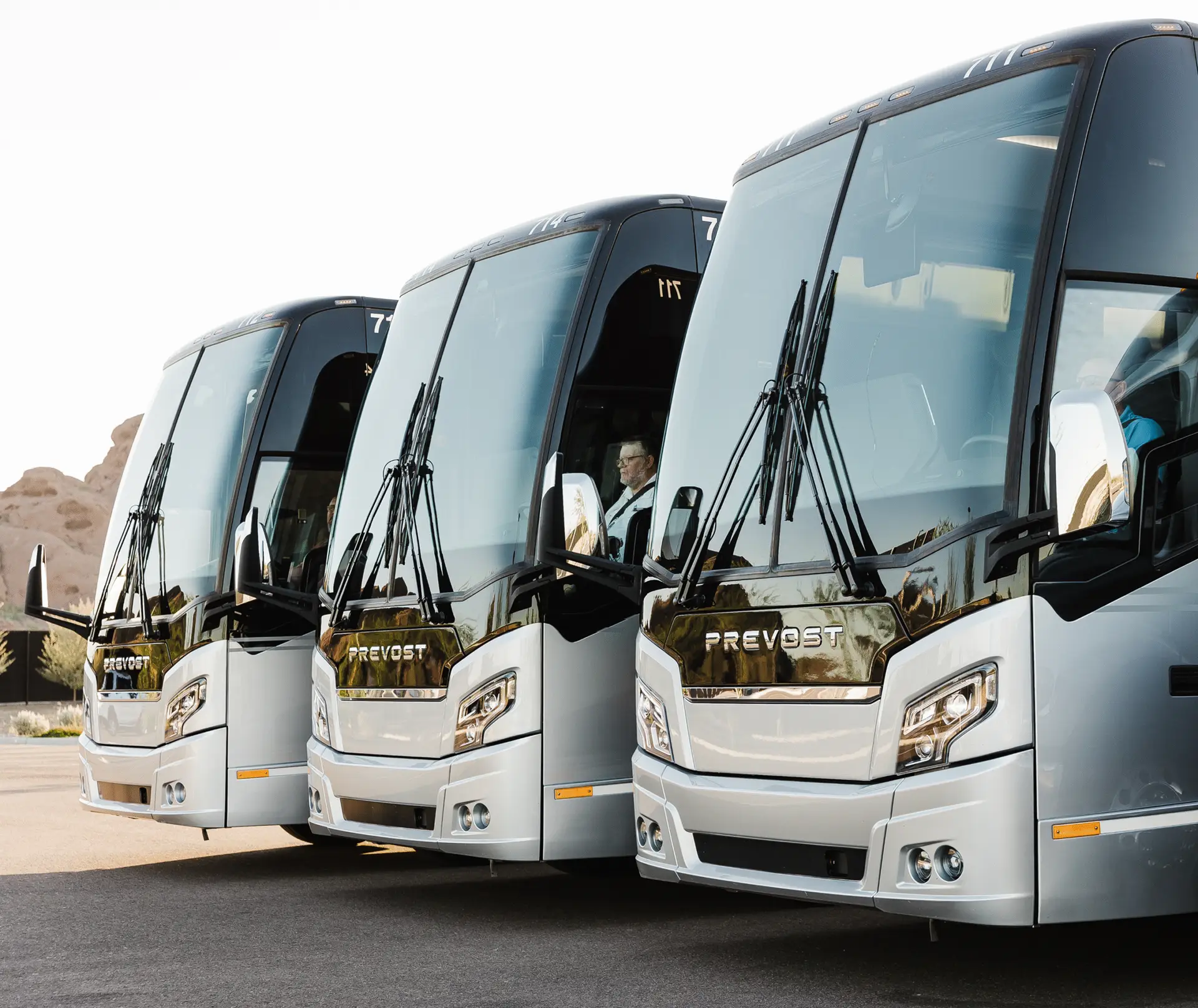 Three Prevost motorcoaches lined up side by side, representing the commercial bus fleet repair and maintenance services offered by All Aboard America in Arizona and Texas.