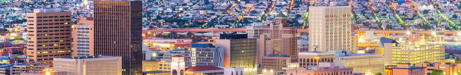 Aerial nighttime view of the El Paso Texas skyline served by All Aboard America charter bus services