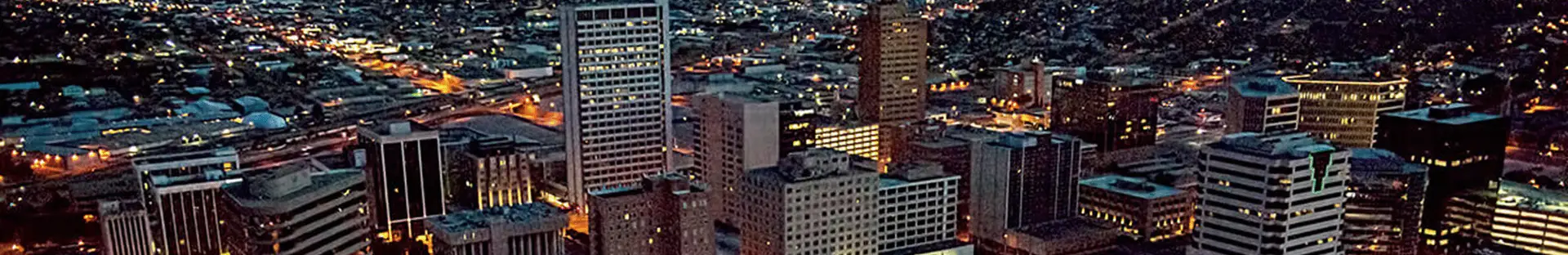 Aerial nighttime view of the Midland Texas skyline served by All Aboard America group transportation services