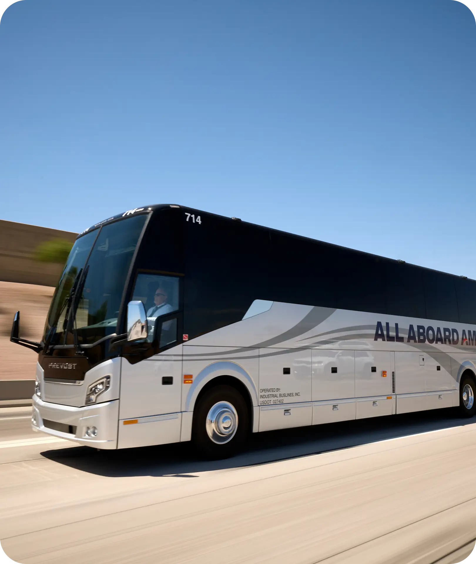 An All Aboard America Prevost motorcoach number 714 travels at highway speed on a clear day